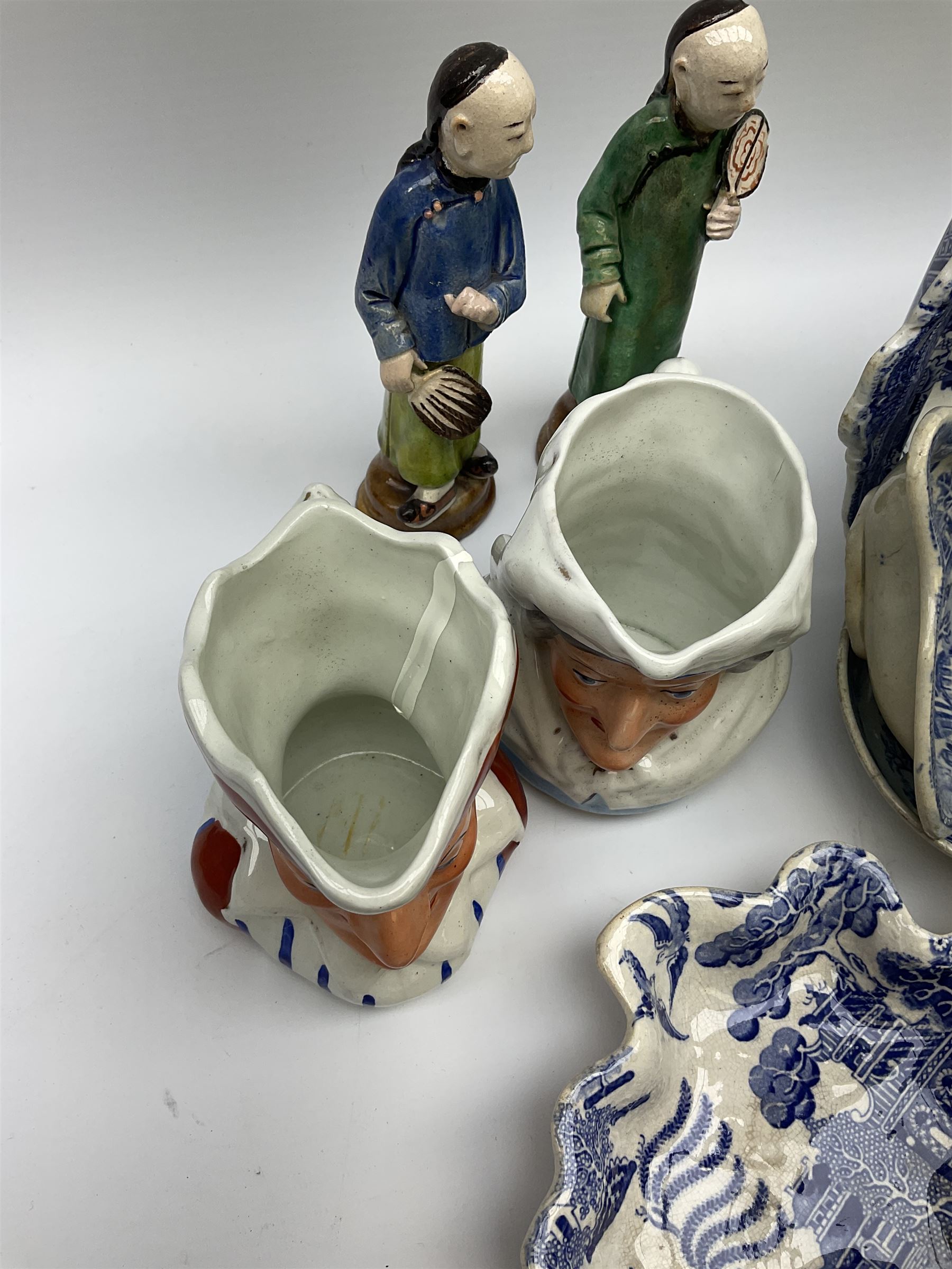 Two 19th century blue and white pickle dishes, each decorated in a variant of the Willow pattern, 19th century blue and white Willow pattern dessert dish, further Willow pattern dish, two black basalt jugs, small Victorian cockle dish, plus a group of Victorian and later figures, to include two Staffordshire arbour groups, one with beehive, Staffordshire style model of a sheep, two Sitzendorf monkey band figures, a Continental figure group modelled as a dancing couple, Atlas China figure of a Satyr, two jugs modelled as Punch and Judy, Rd no 139844, etc. 