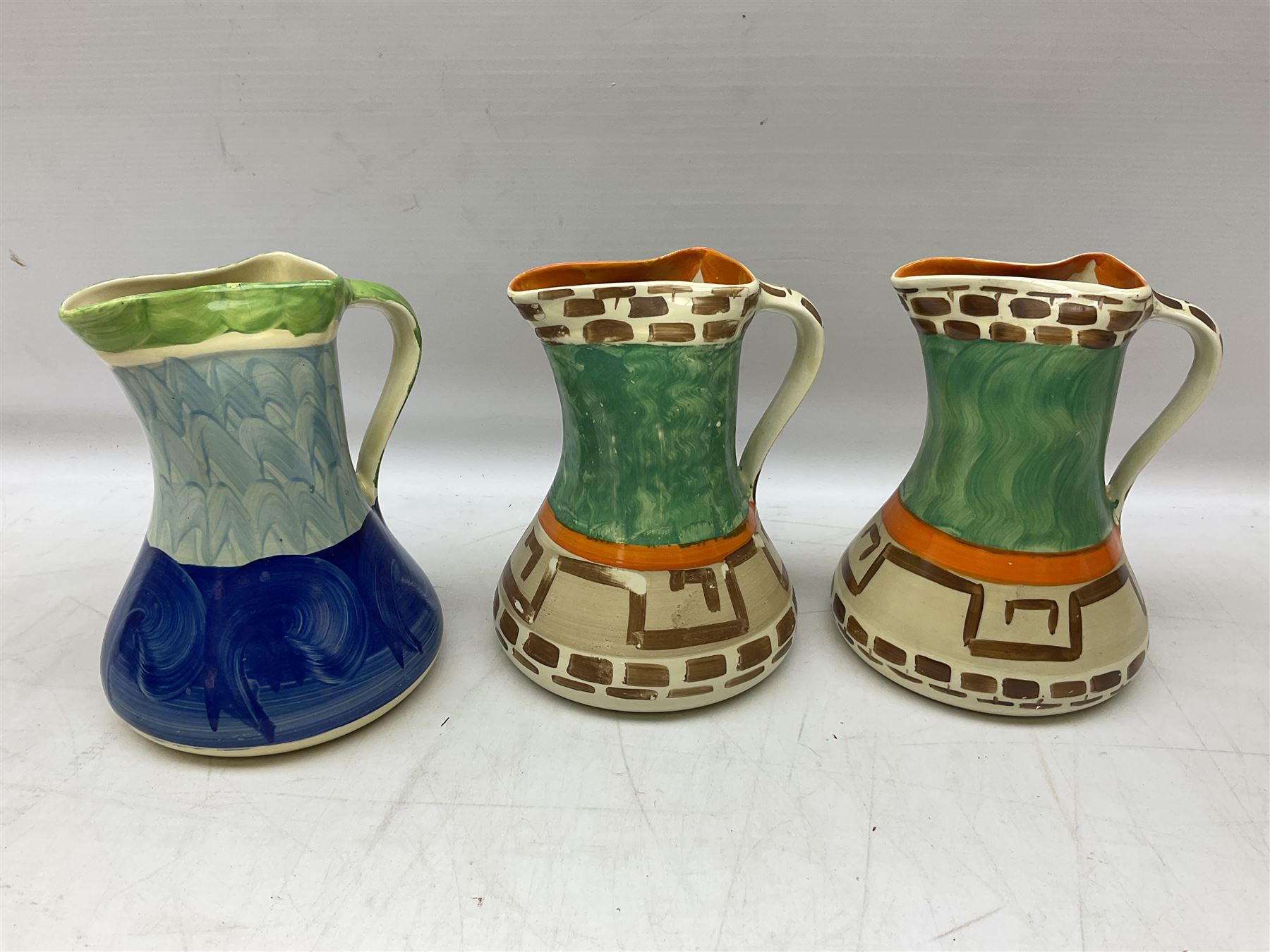 Seven Myott Son & Co hand painted jugs, all with printed mark beneath, H21cm