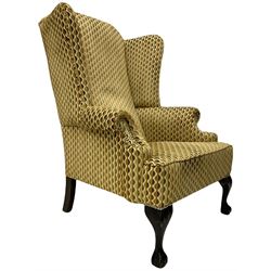 Georgian design armchair, high wing back, mahogany ball and claw feet, upholstered in embossed studded fabric