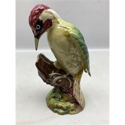 Three Beswick figures of birds, comprising pheasant no 1225, magpie no 2305 and woodpecker 1218, all with impressed marks beneath, tallest H22cm