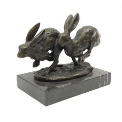 A bronze figure group, modelled as two hares in chase, signed Nick and with foundry mark, upon a rectangular marble base, overall H11cm L13cm