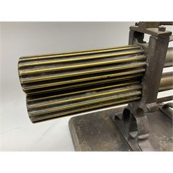 Victorian cuff and collar tabletop mangle, the ribbed brass rollers in a cast iron frame mounted on a wooden base