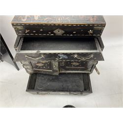  Late 19th / early 20th century Japanese lacquered table top cabinet, heavily decorated with mother of pearl inlay depicting blossoming branches, flowers and birds, the two hinged doors between longer drawers opening to reveal interior fitted with four short drawers, with lift up hinged canted lid, H28cm D9.5cm W23cm, together with mother of pearl inlaid miniature folding screen, dish decorated with walking figures with crimped edge, boxes decorated with flowers, birds and gilt etc