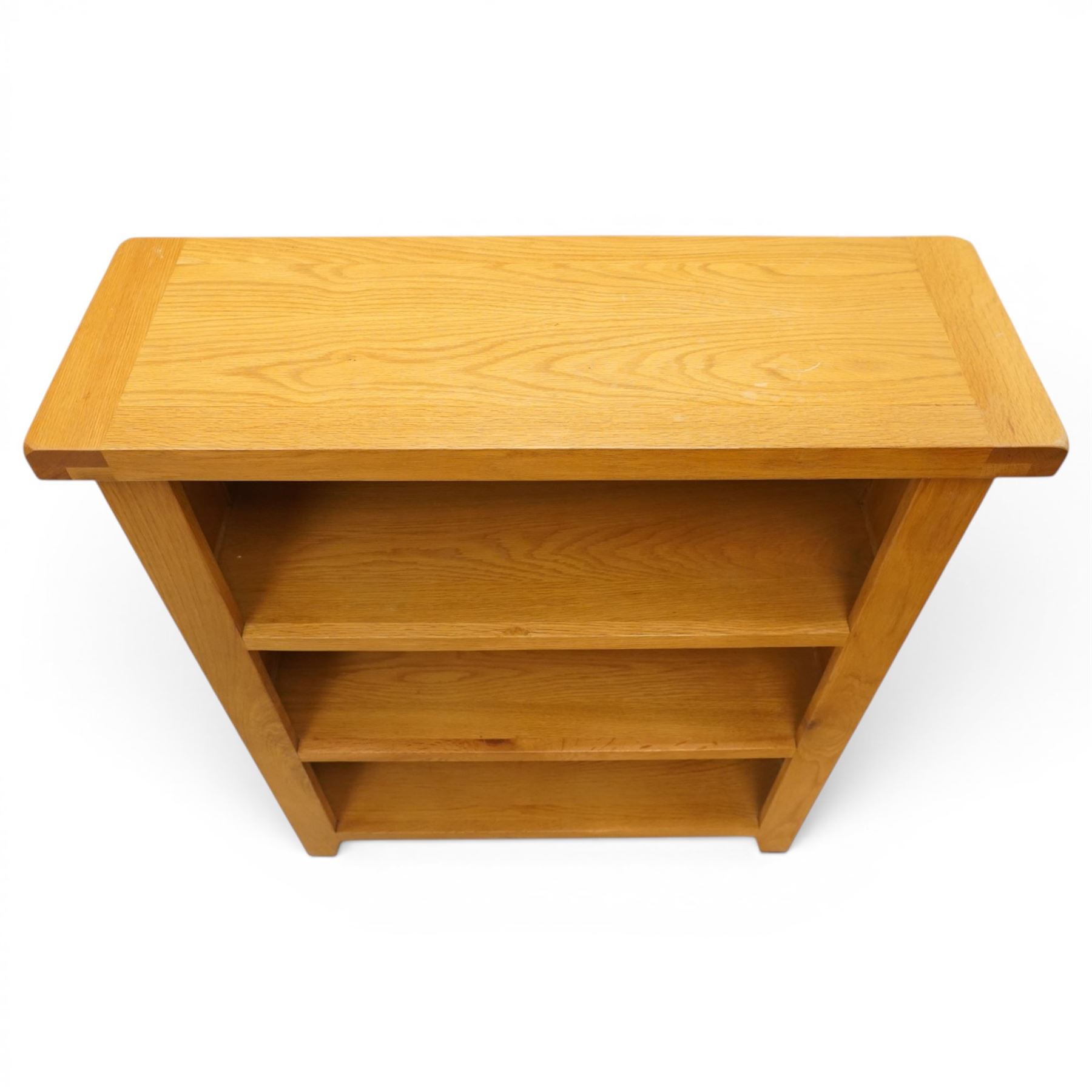 Contemporary solid oak open bookcase, rectangular top over three shelves, on chamfered square feet