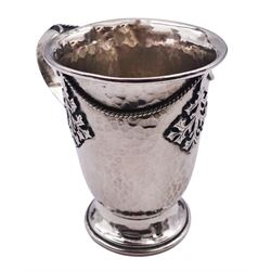 Arts & Crafts silver christening mug, of slightly tapering form with folded rim and curved handle, upon a spreading circular foot, decorated with hammered finish and applied ivy leaf and rope detail, hallmarked Amy Sandheim, London 1904, H8.5cm, approximately 3.45 ozt (107.2 grams)