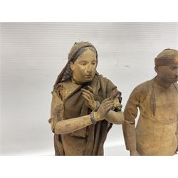 Seven 19th Century Indian clay dolls, possibly Krishnanagar, each figure with painted details, wearing cloth garments, standing on rectangular bases, some with paper label to the base, H25cm