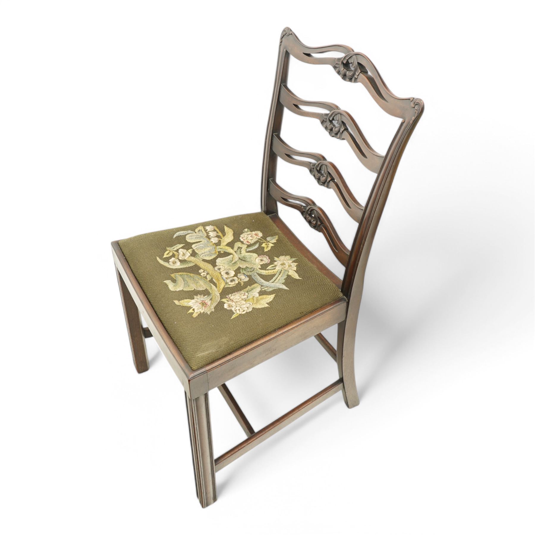 Set of eight (6+2) early 20th century Chippendale design mahogany dining chairs, waved and pierced ladder back carved with shells and curled leaves, moulded upright rails, dished seats with upholstered drop-in seat cushions, on square moulded supports united by plain stretchers 