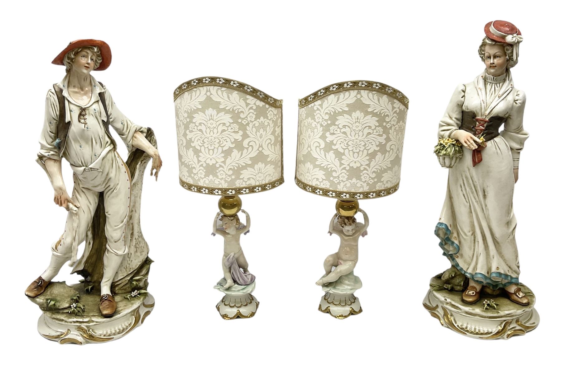 Pair of Capodimonte table lamps, in the form of cherubs holding a brass fitting, together with a pair of large Capodimonte figures in the form or a man and woman resting up on tree stump, largest example H57cm