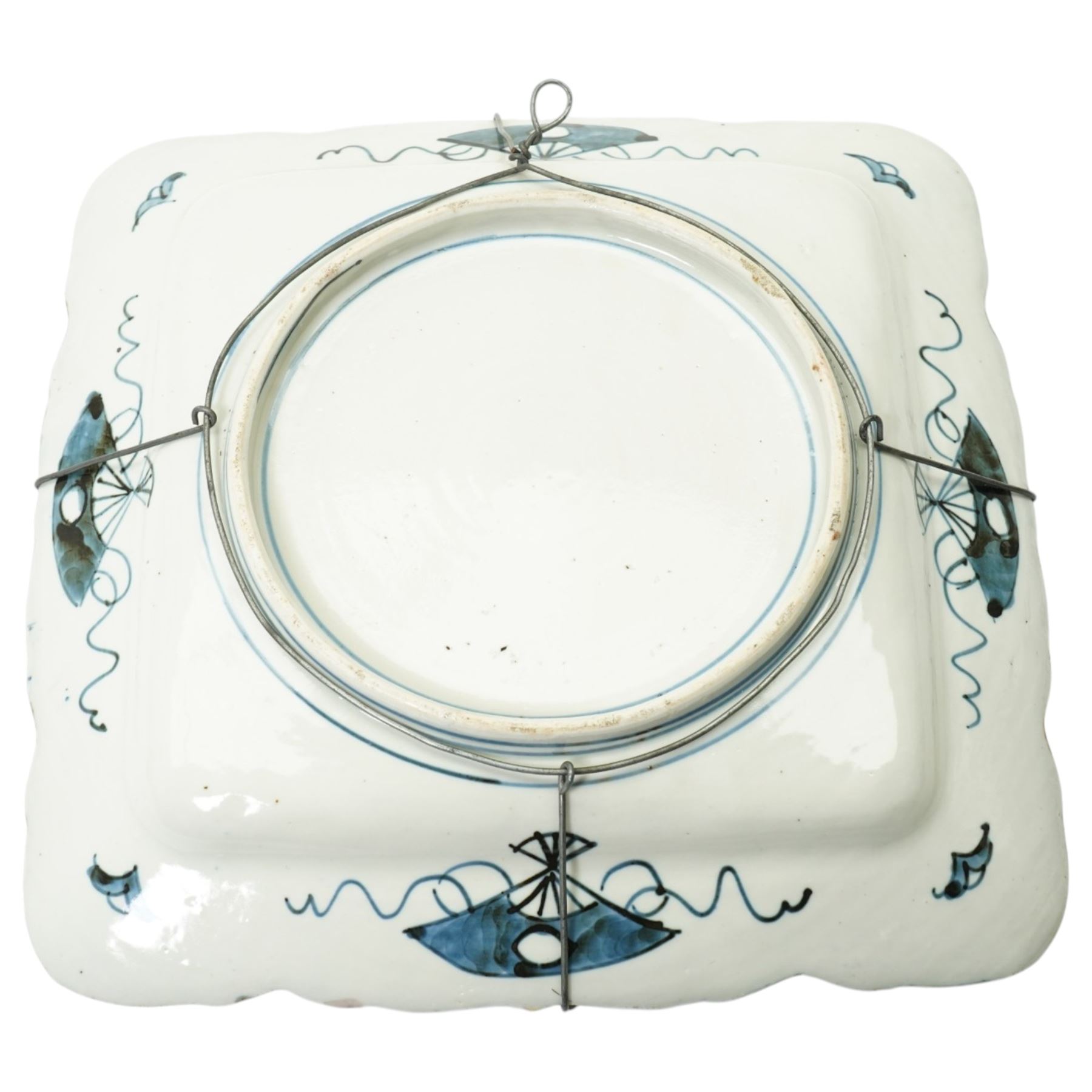 Late 19th/early 20th century Japanese Imari square dish decorated with flowers 32cm and an Indian linen wall hanging decorated with elephants, carriages etc in procession 56cm x 170cm