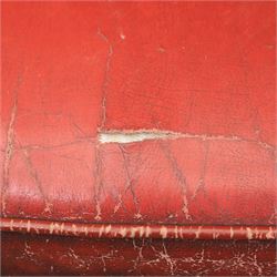 Georgian design wingback armchair upholstered in oxblood leather, the deep button upholstered back with shaped wings and out-scrolled arms, close nailhead trim to the edges, over a loose seat cushion, raised on cabriole front supports terminating in claw and ball feet