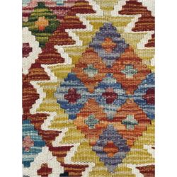 Chobi Kilim flatweave rug, cream ground with a multicoloured geometric diamond field, framed by a bold border of repeating stylised motifs, finished with braided corner tassels