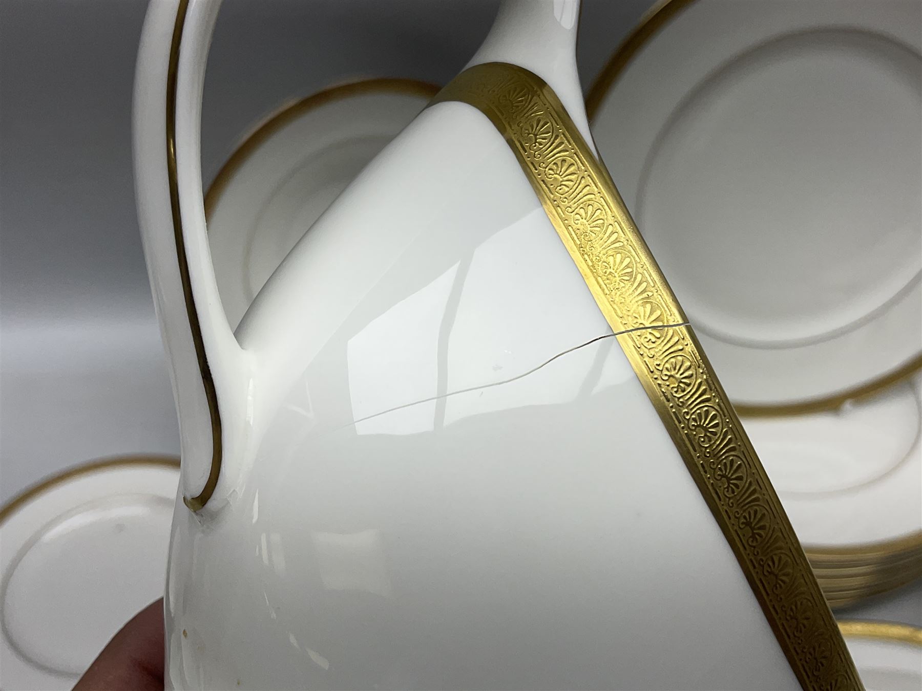 Royal Doulton Royal Gold pattern tea and dinner service for eight, comprising dinner plates, side plates, tea plates, soup bowls, sauce boat and saucer, dessert bowls, coffee cans and saucers, teacups and saucers and two lidded tureens