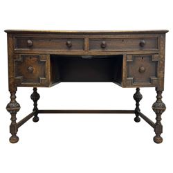 Early 20th century Jacobean design oak desk, with rectangular top inset with worn tooled leather, two frieze drawers over pedestals each fitted with a pair of panelled drawers, turned handles, on carved and fluted tapering legs united by stretchers 