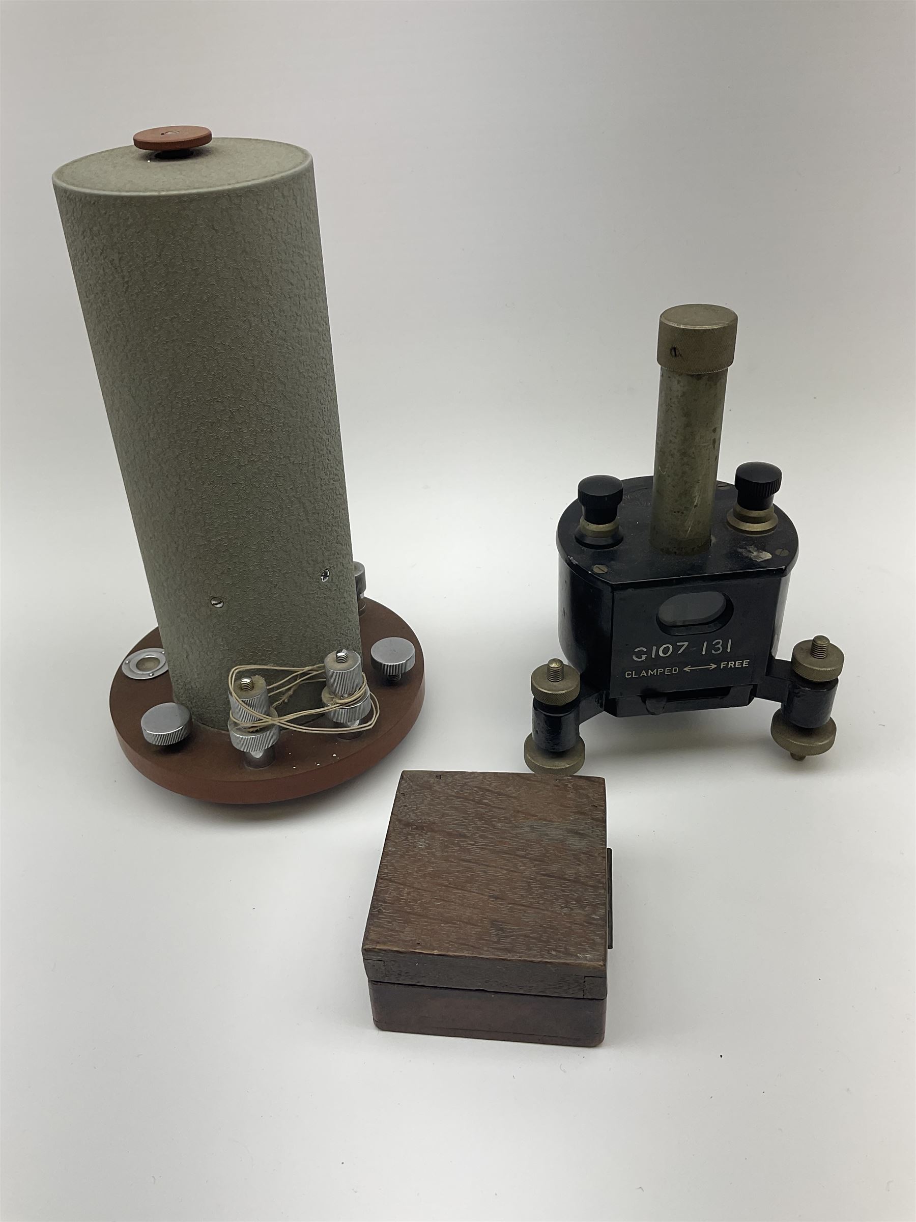 Two mirror galvanometers - one marked Sullivan Galvanometer serial no.1483/1950 of green crackled cylindrical form on circular base H24cm; the other by W.G. Pye & Co. Cambridge marked G107-131 on tripod base; together with an ammeter in wooden case (3)