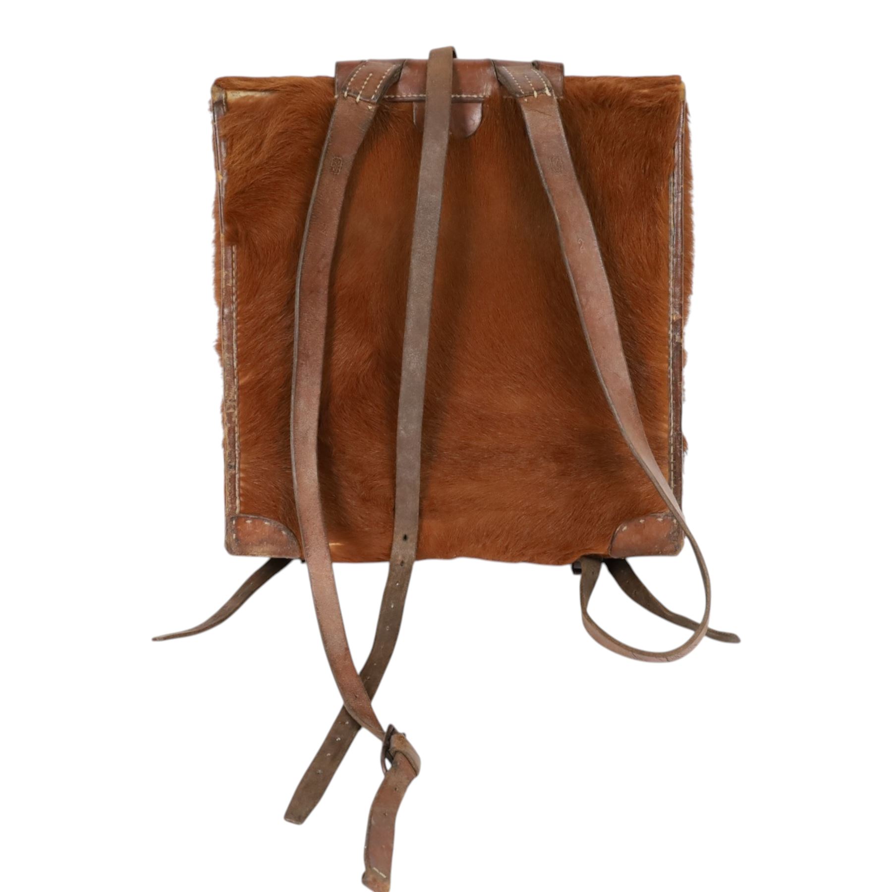 Swiss army pony skin backpack, with rolled leather edges and leather straps, the back straps stamped with Swiss cross over Sch., the fascia enclosing two belted flaps, with cream canvas lining, H38cm, W37cm