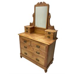Victorian waxed pine dressing chest, raised swing mirror with shaped flower head carved pediment, small trinket drawers over two short and two long drawers, skirted base, on turned feet