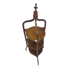 Edwardian inlaid mahogany cake stand, three circular tiers united by shaped supports with central top finial
