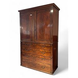 Victorian mahogany linen-press, moulded cornice over two figured panelled doors, the interior fitted with five slides and hanging rail, four long drawers below 