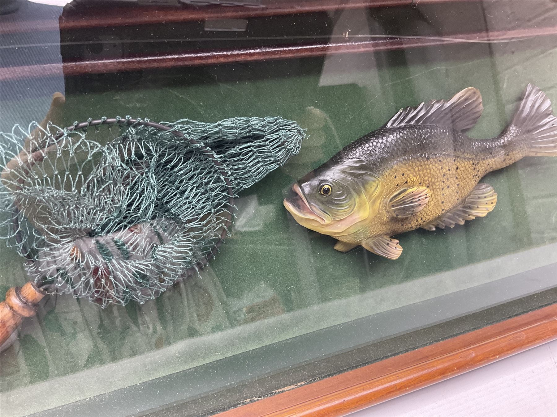 Four framed sporting memorabilia displays, the largest example containing 1930s cricket memorabilia, together with two fishing displays and a football display, each within wooden glazed frames, largest H105cm