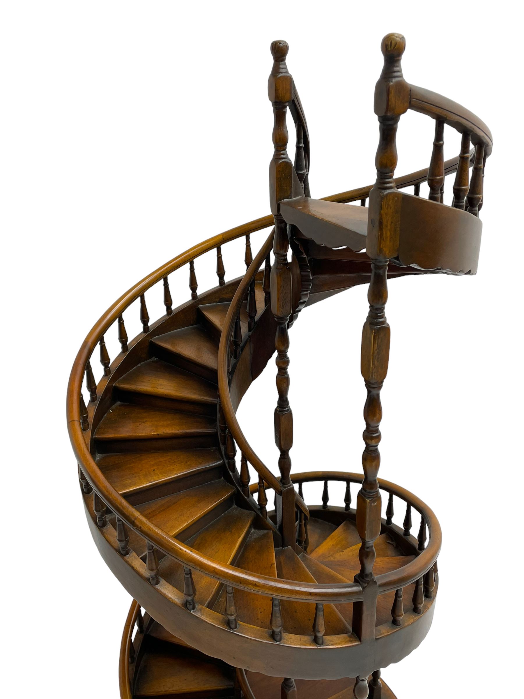 Miniature fruitwood spiral staircase, turned newel posts and balusters, rounded handrail, on circular moulded base