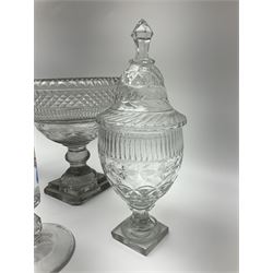 19th century and later glassware, comprising cut glass pedestal sweetmeat bowl, with hobnail cut decoration, upon knopped stem and square stepped foot, together with a pair of cut glass sweetmeat jars and covers, each upon faceted stem and square stepped foot, the cut glass domed covers with conforming faceted finials and a pair of heavy glass candlesticks, each upon faceted knopped stem and circular spreading foot, tallest H32.5cm