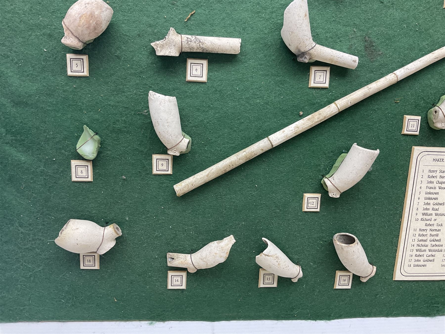 Annotated display board of clay pipes; rootwood walking stick and Yorkshire CCC signed cricket bat 2001