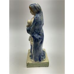 Late 18th century Prattware figure representing Charity, modelled as a mother with baby in her arms and two small children clutching at her robes, upon a square base, overall H21cm.