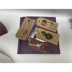 Five Charlie Bears Plush Hug Book Collection books, comprising Guide To Snuggleability containing Snuggleability CB191971F, Paw-Some Facts Directory containing Pawsome CB191971D, Bear Therapy Handbook containing Bear Therapy CB191971E, Study Buddy Handbook containing Study Buddy CB191971A, and Guide to Being Bear-illiant CB191971B, each designed by Isabelle Lee, each with tags, plus Charlie Bears Secret Hug Book (lacking contents), together with assorted Charlie Bear accessories, to include two Bear Ears Duffle headbands CBBEARSDUF, Egg Cup CB185198 , Incy Wincy CB205252AO, with tag, four key rings, all with tags, Bear Care Kit and contents, recipe cards, pin badges, tape measure, notebook, etc., (Qty)