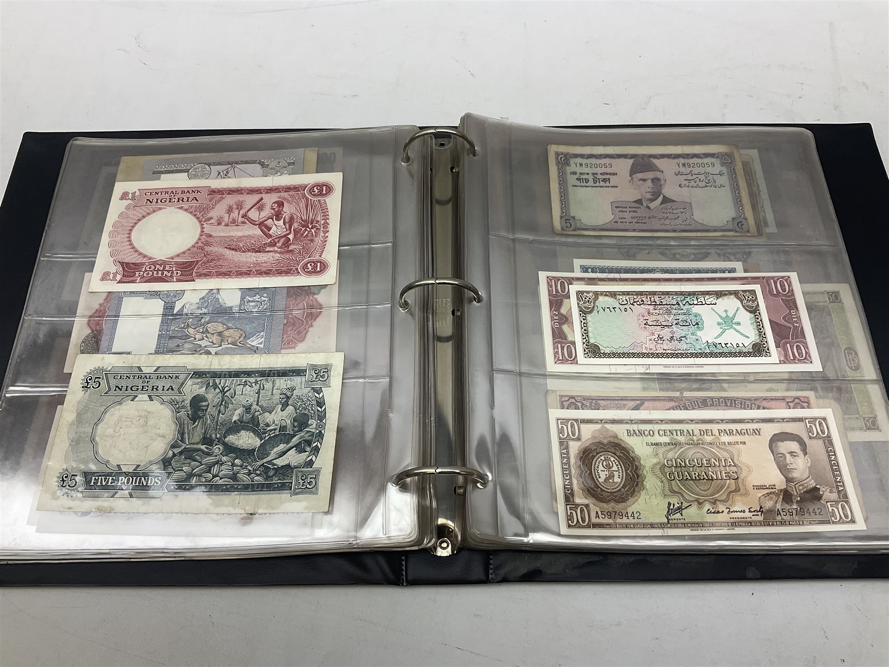 World banknotes, including Queen Elizabeth II The States of Jersey one pound 'DB202703', five pounds 'BB527762' and ten pounds 'AB651481', reserve bank of New Zealand two dollars '1L3 741894', King George V Straits Settlements one dollar 1st January 1935 'F/83 28924', various Bank of England notes etc, housed in two ring binder albums