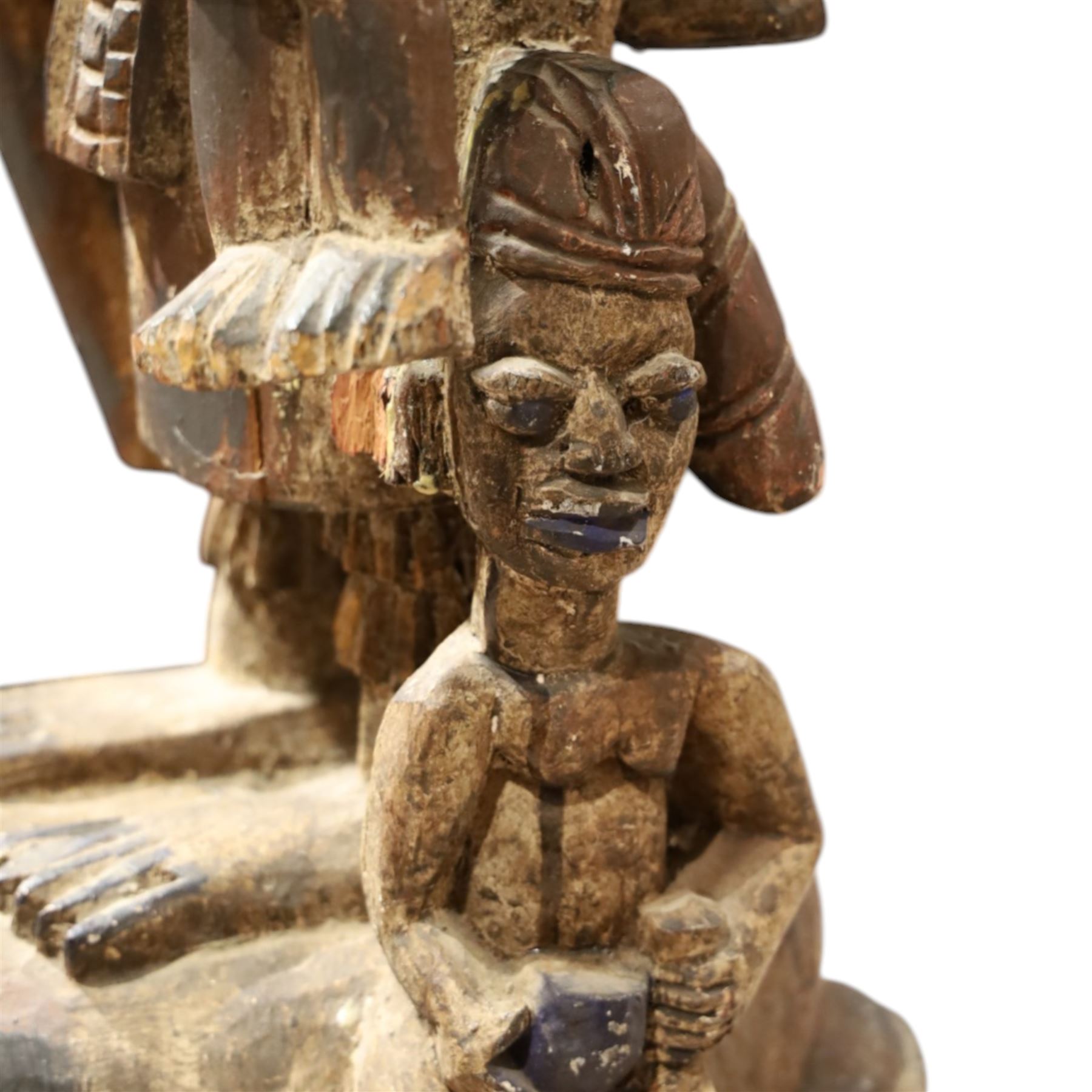 African tribal maternity figure of a woman with children, probably Yoruba, carved wood, the woman stood upon a craved mask, H133cm
