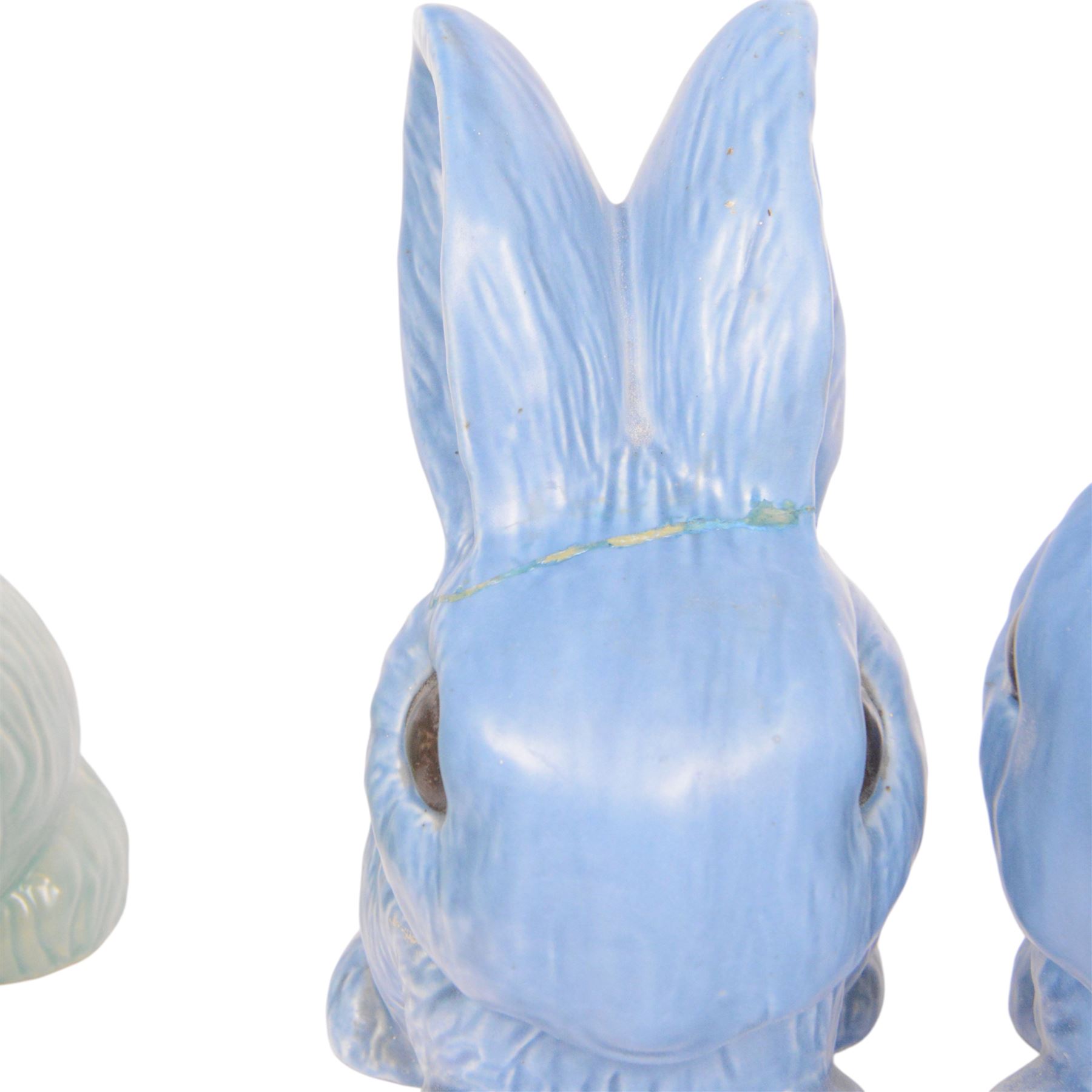 Nine Sylvac rabbits, including models 1028, 990, 1026 etc, in blue and green, largest H25cm  