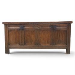 Large 17th century oak coffer, plank top with moulded edge, four panel front with channel moulded uprights, retaining original wrought iron strap hinges and central lock plate, panelled ends, raised on stile supports