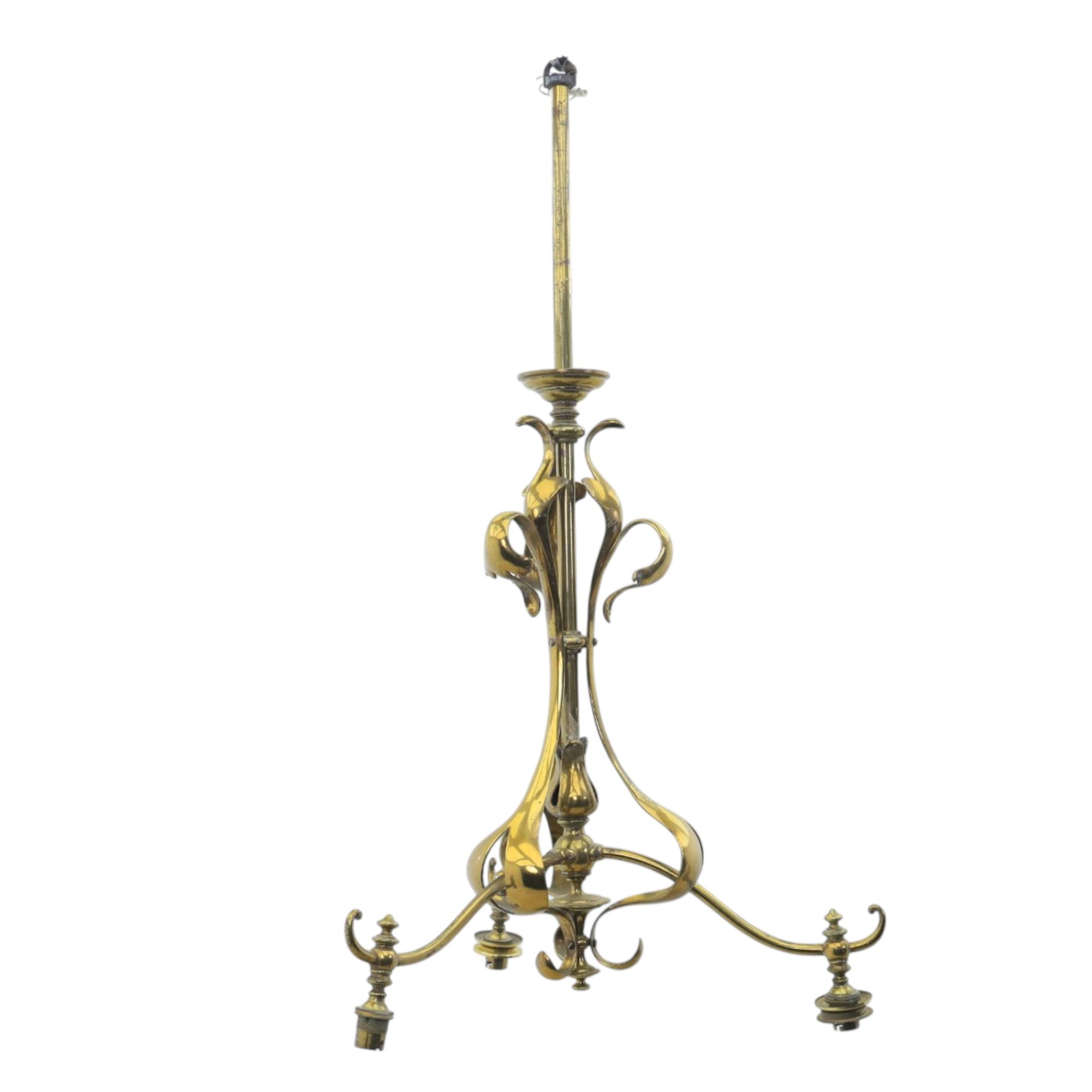 20th century Art Nouveau brass wall light, vertical stem with three scrolling arms terminating in lamp holders, central baluster element with curving supports
