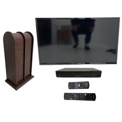Panasonic 32 inch TV with DVD player and wall bracket and CD rack including various CDs 