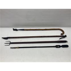 Two late 19th century fruit picker canes, the first example a French ebonised bamboo cane, with pair of fruit scissors to base, the handle stamped Cueille Fruit, the second example with grabbing action, the cap stamped A C Harris, Leicester, together with two other 19th century canes, one with fork and the other with hoe