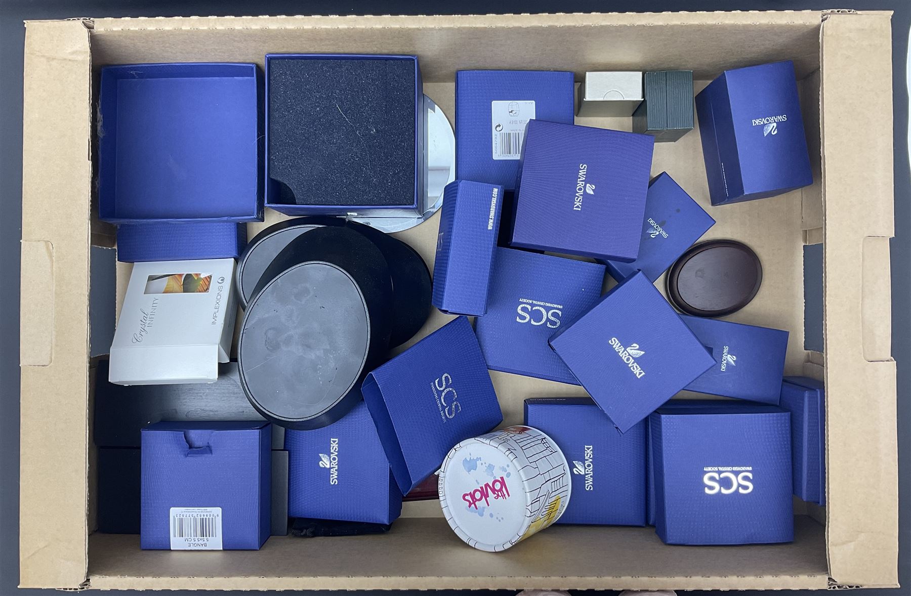 Swarovski Crystal paperweights, to include a globe with dove to the top, pyramid shapes etc, together with a large collection of boxes and stands  