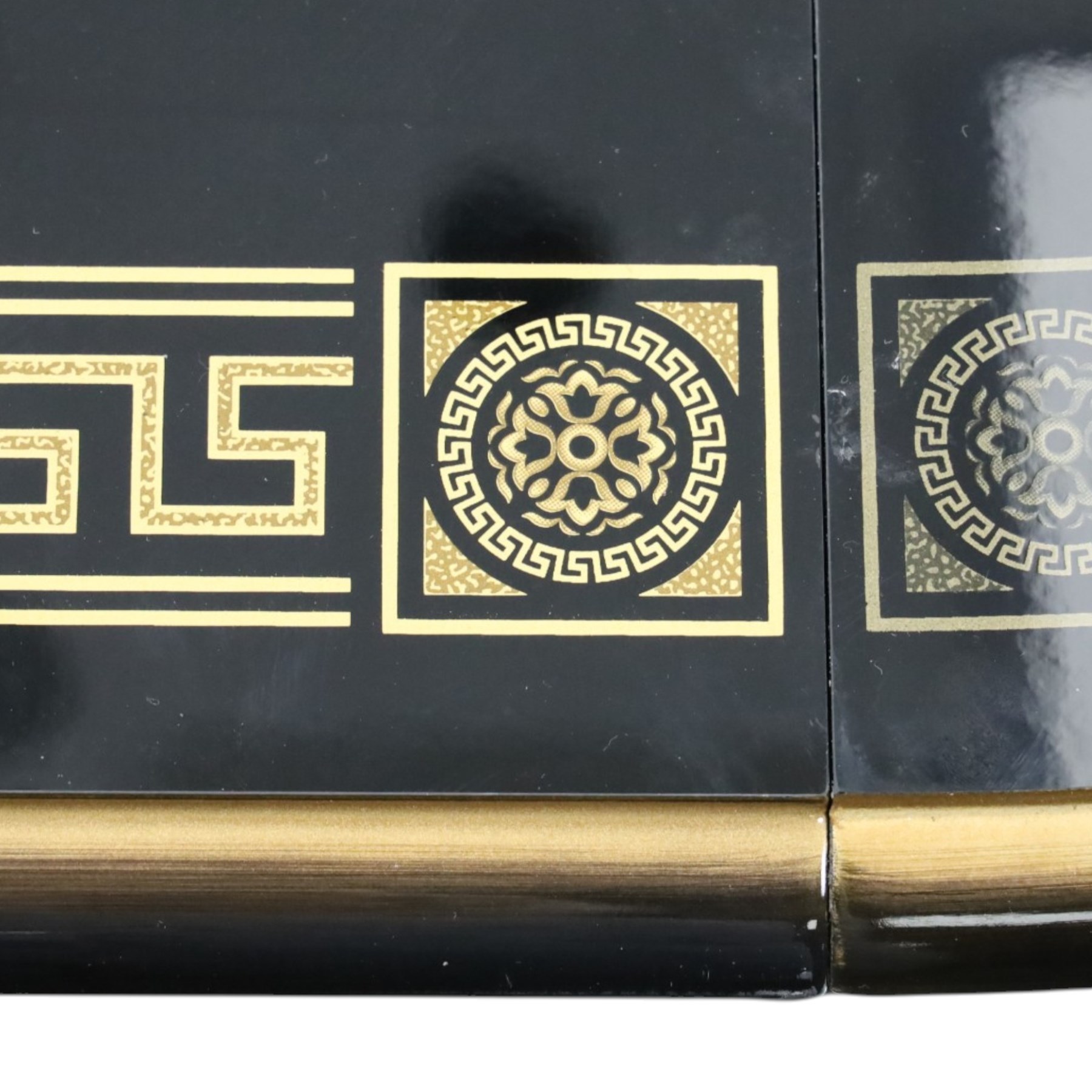 Italian Neoclassical inspired ebonised gloss dining table with four matching chairs,  circular top with additional leaf (Extends to  145cm) with Greek key banding, on a shaped pedestal base with gilt highlights and stepped plinth, the chairs en suite with padded back and seat with Greek key, reeded front supports