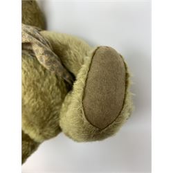 Early 20th century German Steiff teddy bear c1910 with wood wool filled humped back mohair body, swivel jointed head with black boot button eyes and horizontally stitched black nose and mouth, FF metal button to left ear, jointed elongated limbs with felt paw pads and black stitched claws H13