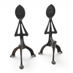 Arts and Crafts cast iron and brass andirons, brass and copper acorn finials above openwork uprights, raised on shaped arched feet with hammered detail