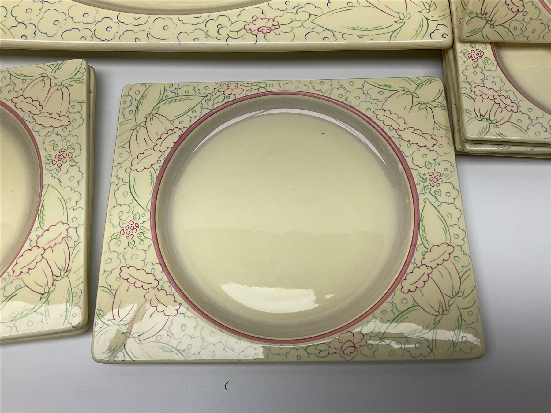 Clarice Cliff Biarritz part dinner set, circa 1930, for Royal Staffordshire, of rectangular form, decorated with bluebells, to include one serving plate, six dinner plates, three side plates, etc, printed mark beneath with reg no 784849 (17)