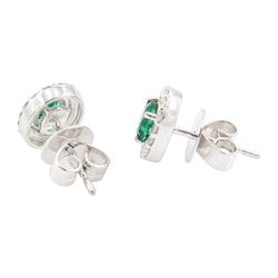 Pair of 18ct white gold emerald and diamond cluster earrings, each stud set with a single oval cut emerald, surrounded by a halo of round brilliant cut diamonds, stamped 750, total emerald weight approx 0.80 carat, total diamond weight approx 0.15 carat