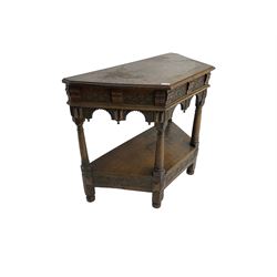 Jacobean design carved oak side or credence table, demi-heptagon top with moulded edge, frieze carved with foliate C-scroll design above ornate arcade carved apron, under-tier united by ring turned pilisters, lower frieze carved with repeating lunettes