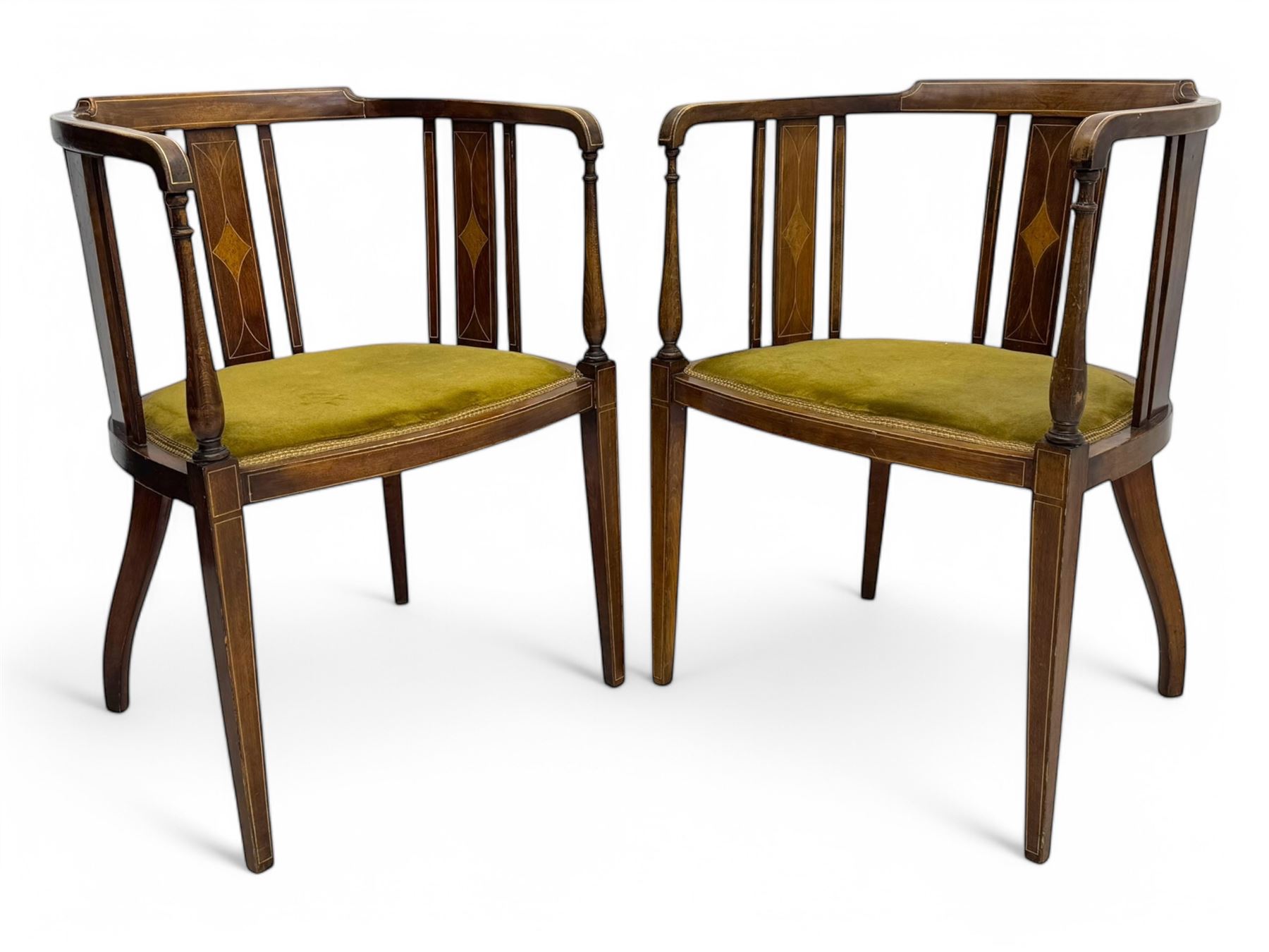 Pair of early 20th century Edwardian inlaid mahogany elbow chairs, shaped top rails with central diamond motif and line inlays, flanked by turned uprights, green velvet seats, on square tapered legs
