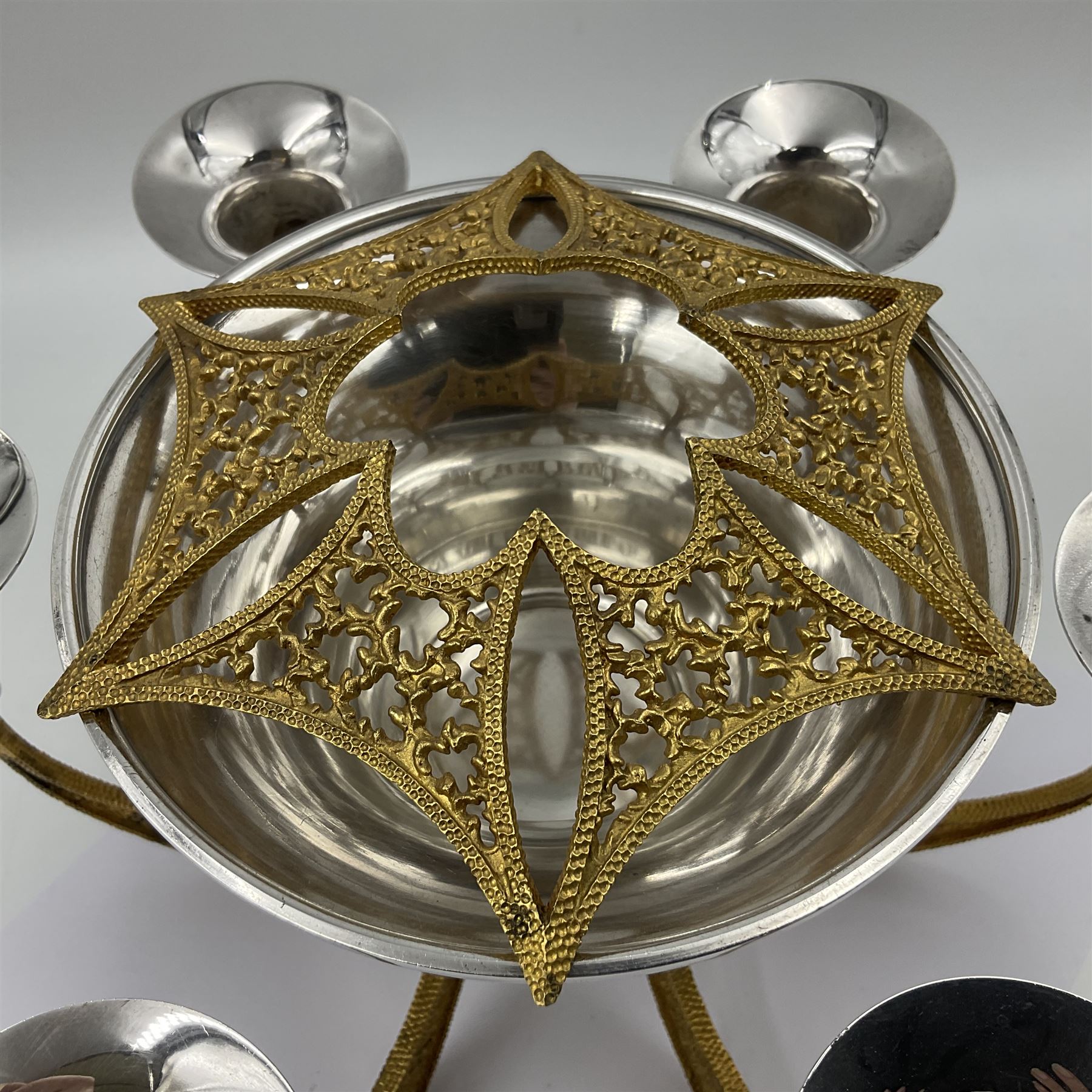 Modernist silver plated candelabra centrepiece by Stuart Devlin, with six pierced gilt branches supporting a central tapering cylindrical rose bowl and six fluted candle holders, with detachable star shaped gilt cover, stamped SD, TG to underside of central bowl, overall H17cm