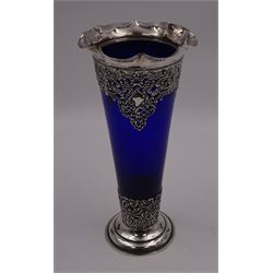Victorian silver mounted blue glass trumpet vase, the silver mounts with pierced and embossed floral, C scroll and lattice decoration, with frilled rim, upon stepped circular foot, hallmarked Henry Matthews, Birmingham 1899