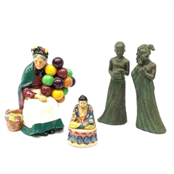 A Royal Doulton figurine, The Old Balloon Seller HN1315, together with a small figure of a seated buddha, marked beneath Japan, and a pair of bronzed composite male and female figures, H20cm. 