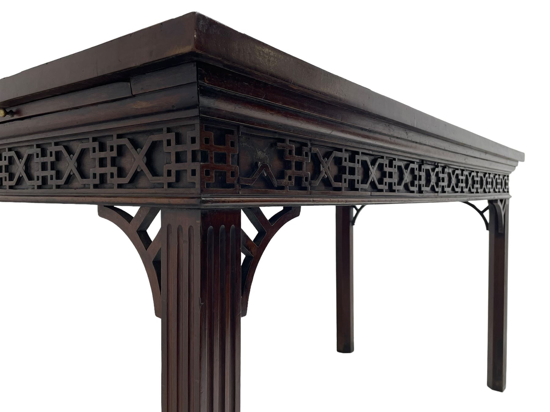 In the manner of Thomas Chippendale - early 19th century mahogany serving table, rectangular crossbanded top with boxwood stringing, the frieze with upper moulding over applied geometric fretwork, the left-hand side fitted with slide, on fluted square supports with inner chamfer 