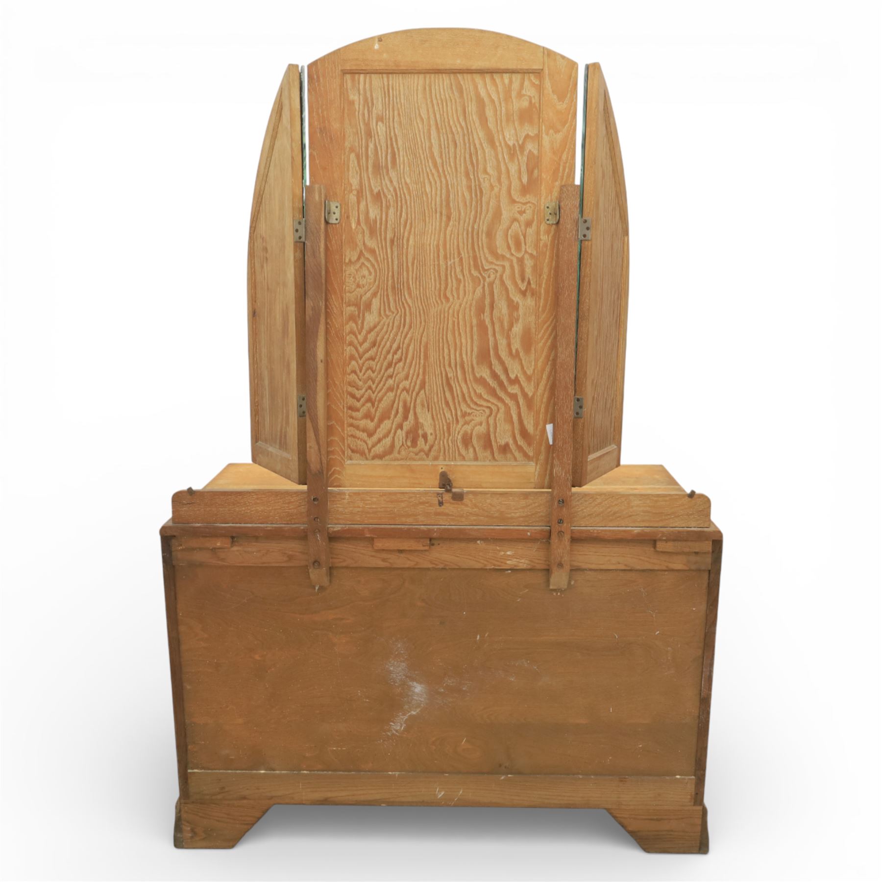 Early 20th century Art Deco bedroom suite, comprising double wardrobe, dressing table and chest of drawers, constructed in walnut with figured veneers and geometric banding, the wardrobe with arched top and panelled doors enclosing a fitted interior, the dressing table with rectangular top below a three panel mirror arrangement, fitted with two short over two long drawers, the chest with three short and three long drawers, each piece fitted with faceted handles and raised on shaped feet
Wardrobe (H 177cm, D 46cm, W 112cm)
Chest (H 85cm, D 48cm, W 92cm)
Dressing table (H 160cm, D 52cm, W 106cm)
