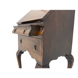 Small early 20th century Queen Anne style bookcase on bureau secretaire, the moulded arched pediment over mirrored door in shaped frame, the bureau fitted with fall front enclosing curved fitted interior, cushion moulded drawer over single drawer, on scroll and shell carved cabriole supports