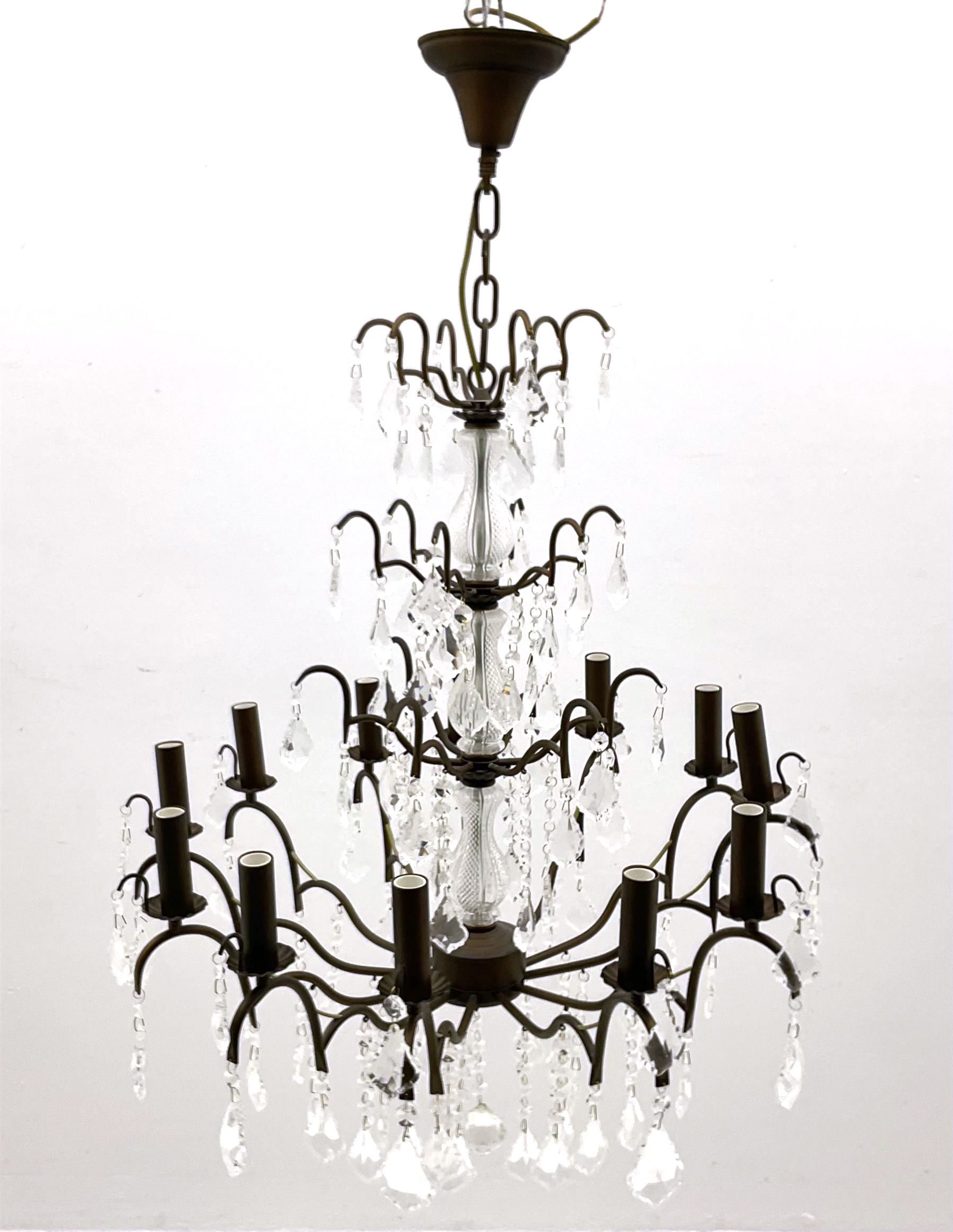 Contemporary bronze finish twelve branch chandelier, decorated with glass droplets 